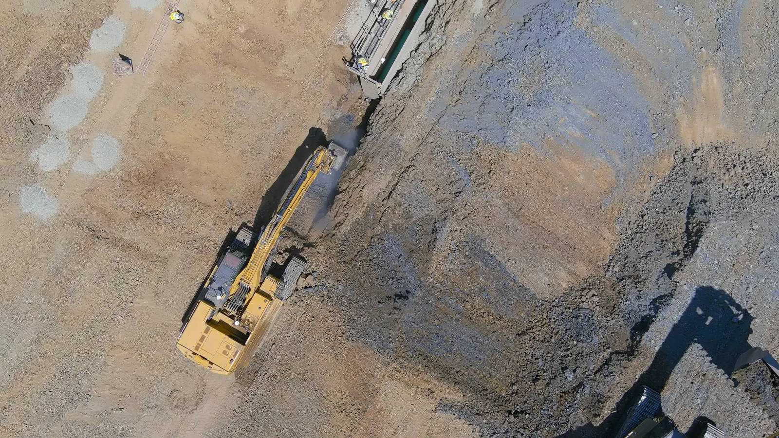 Top-down view of equipment working along a graded slope