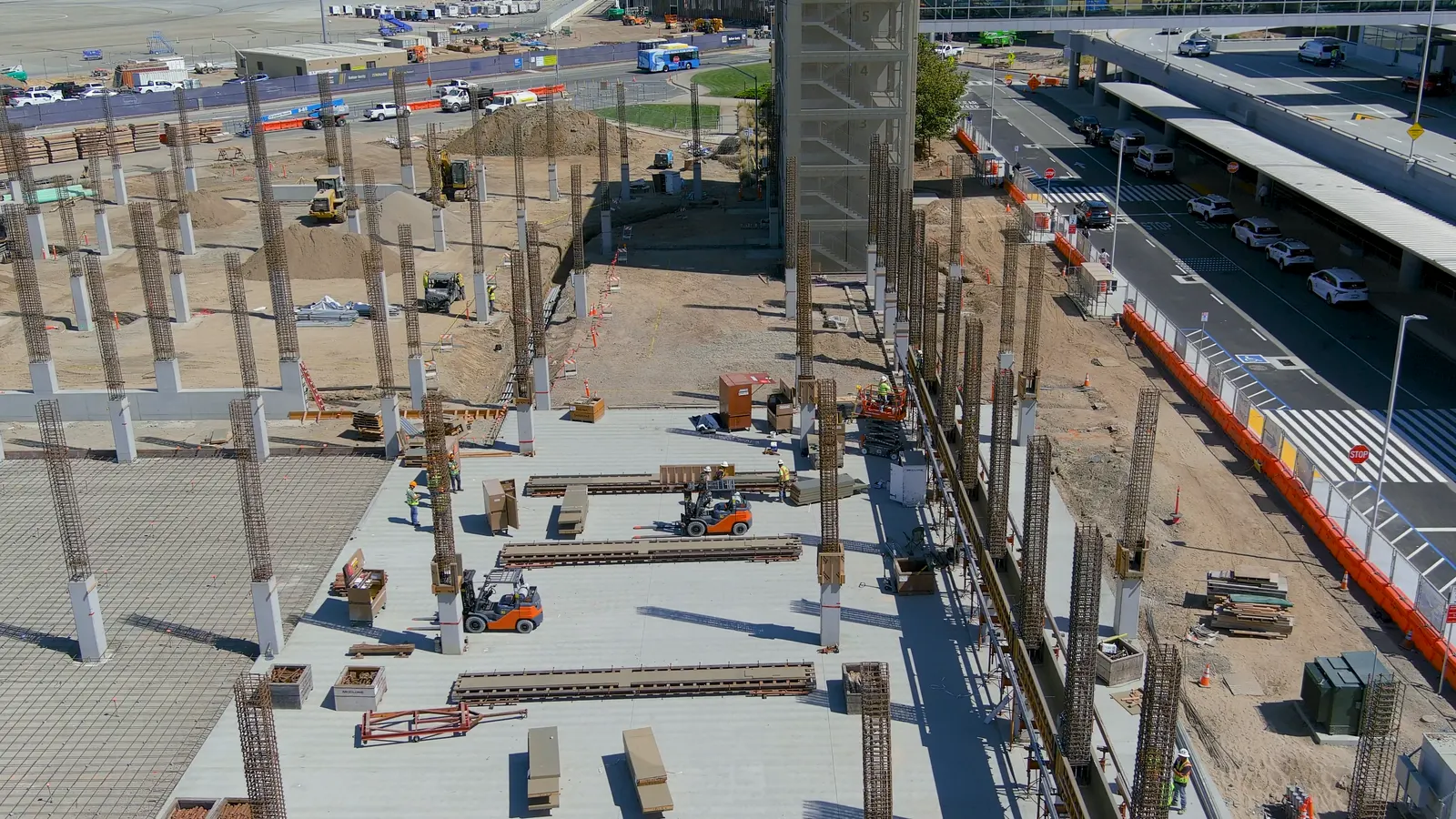 Concrete columns rising on an active construction site