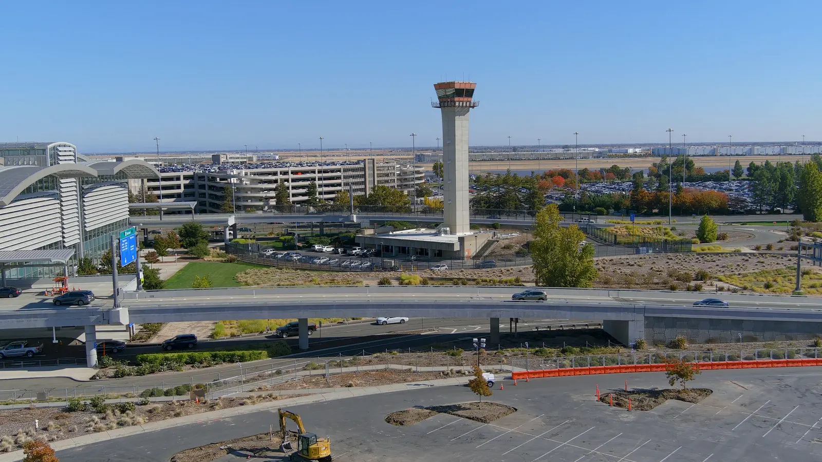 Wide aerial view of an airport terminal and control tower