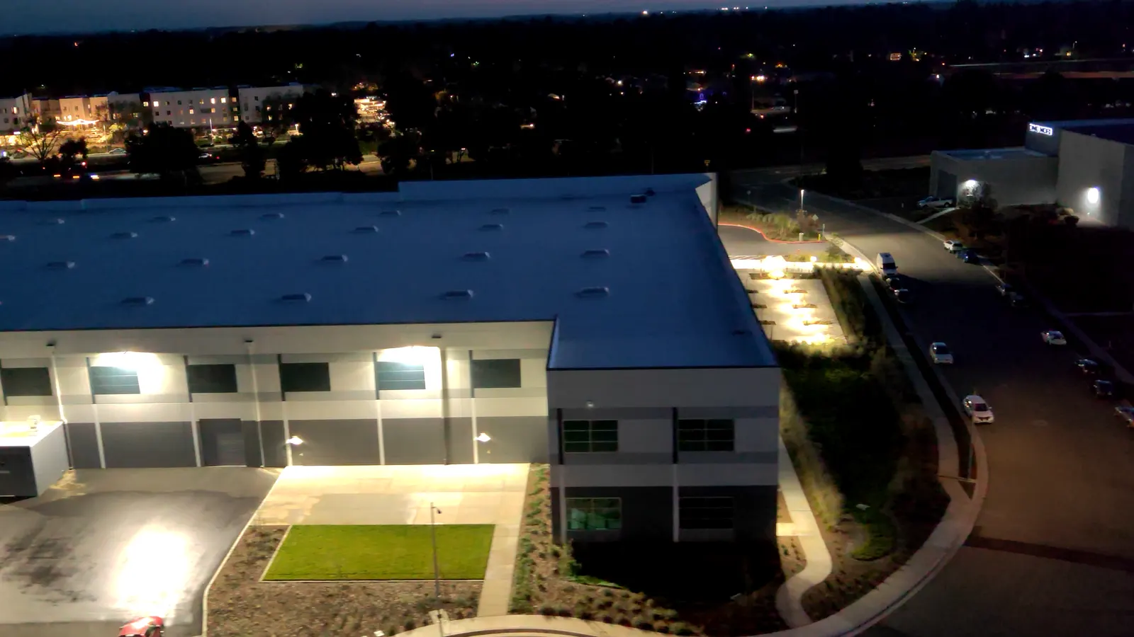 A building lit up at night, seen from above